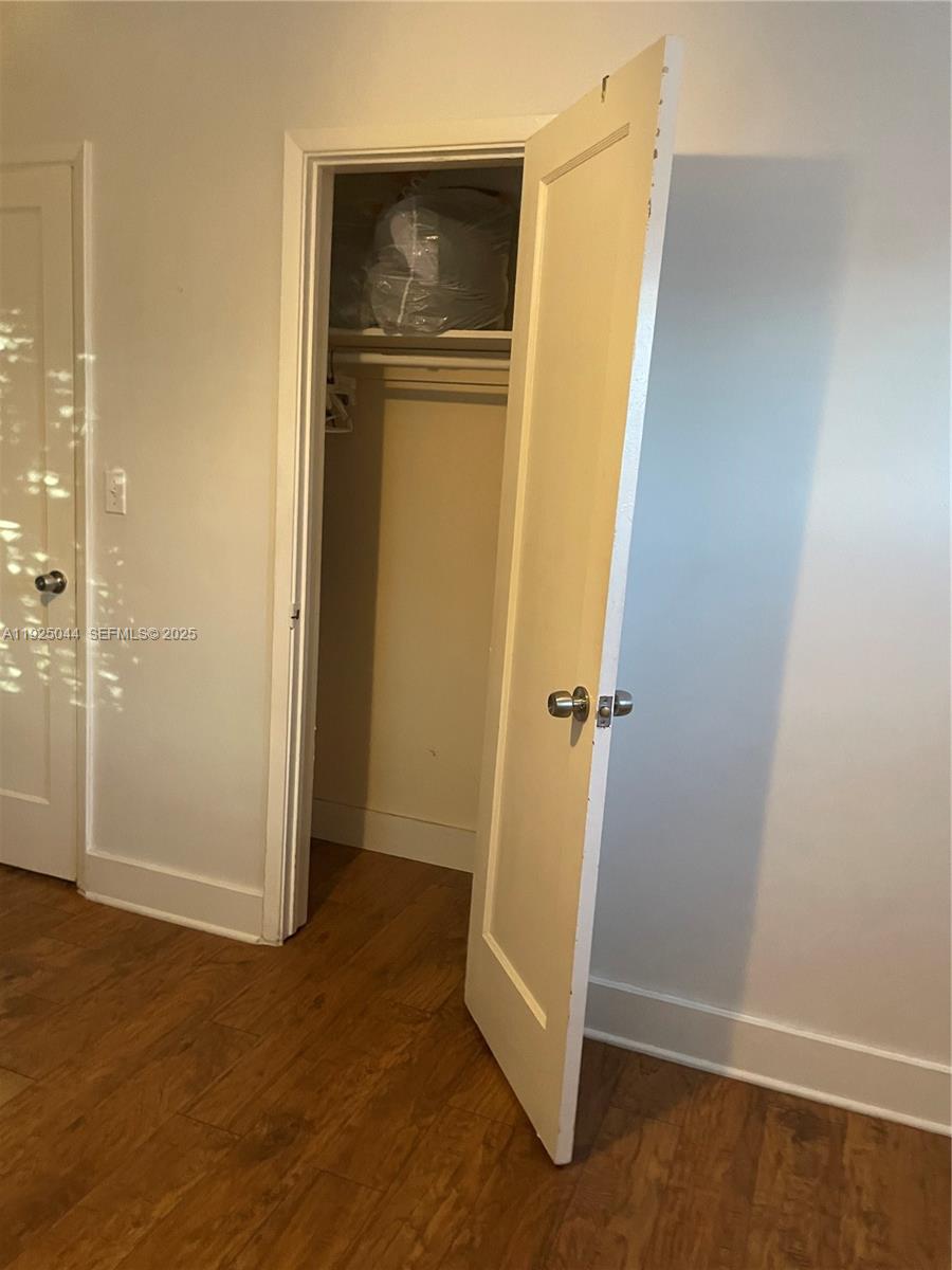 705 East 9th Court Hialeah, FL 33010 - Photo 11 of 36 an empty room with wooden floor and closet