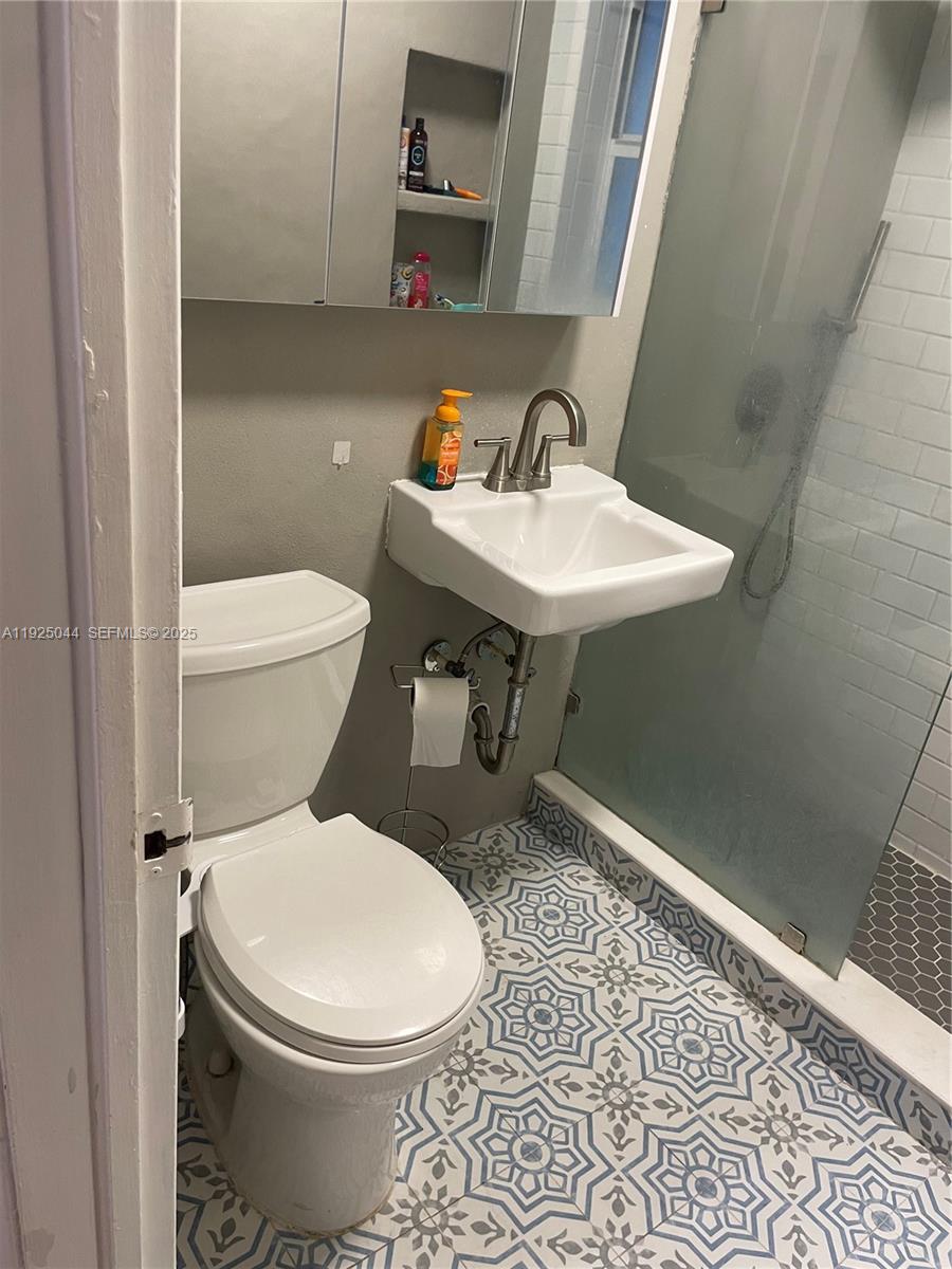 705 East 9th Court Hialeah, FL 33010 - Photo 23 of 36 a white toilet sitting next to a bathroom sink