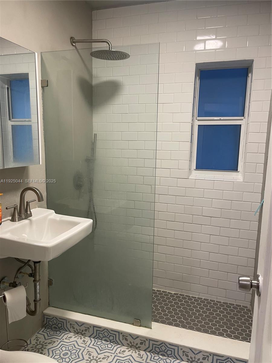 705 East 9th Court Hialeah, FL 33010 - Photo 26 of 36 a bathroom with a sink a toilet and shower