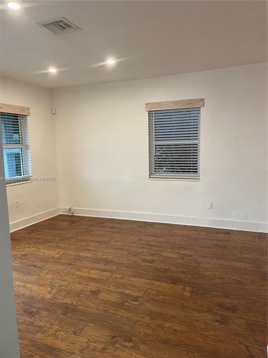 705 East 9th Court Hialeah, FL 33010 - Photo 5 of 36 a view of an empty room with wooden floor and a window
