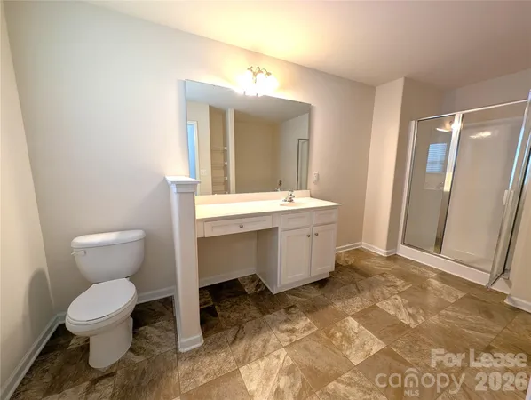 a bathroom with a sink toilet and mirror