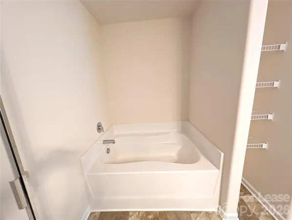 a white bath tub sitting next to a white sink