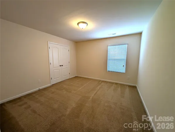 an empty room with a empty space and windows