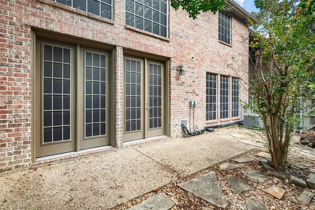 a view of a brick house with a large window