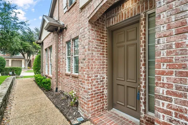 a view of a brick buildings with entryway doors