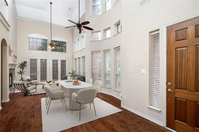 a dining room with furniture window and wooden floor