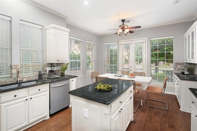 a kitchen with a stove a sink and cabinets