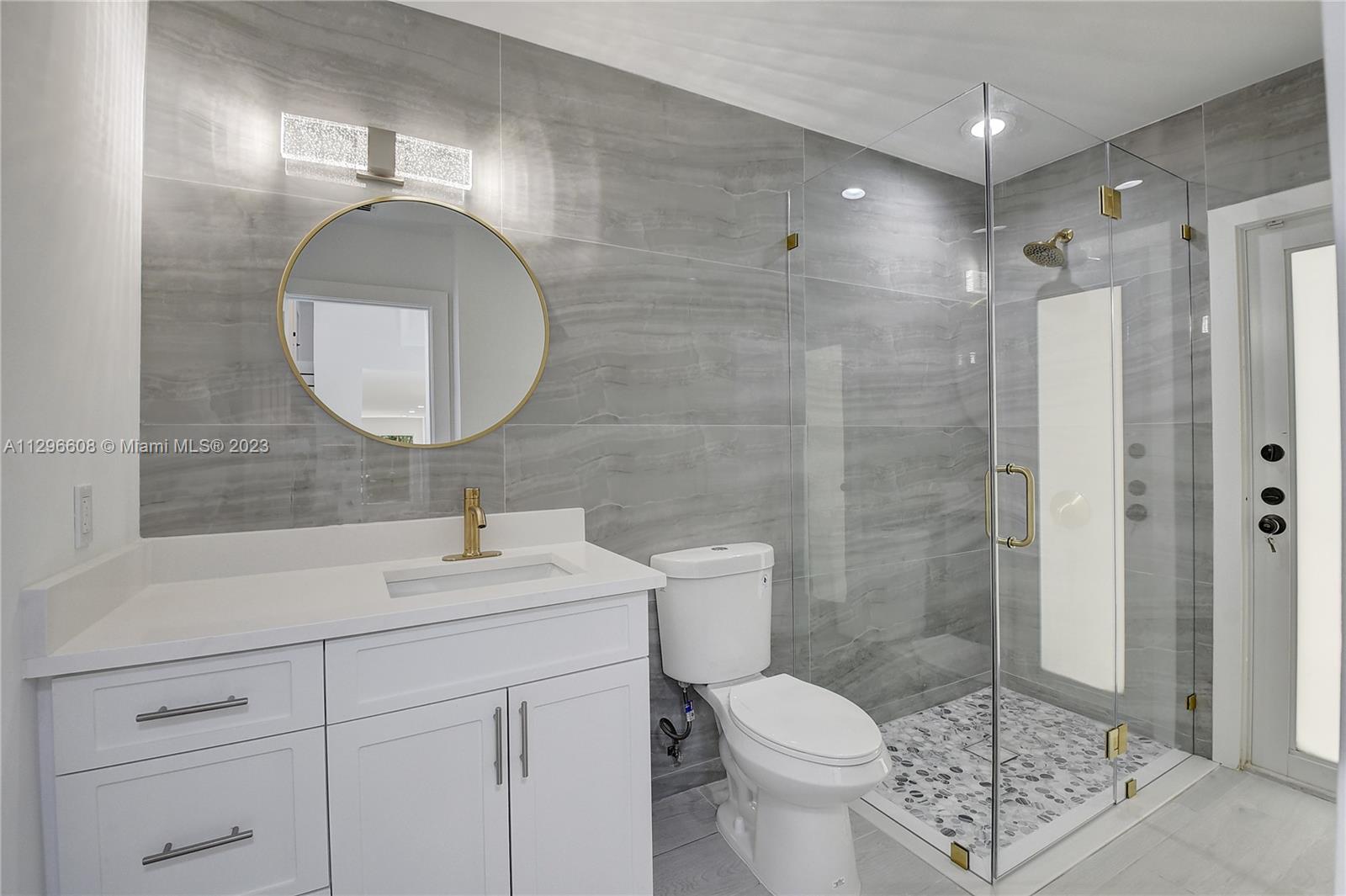 2875 Northwest 28th Street Boca Raton, FL 33434 - Photo 15 of 32 a bathroom with a sink toilet and shower