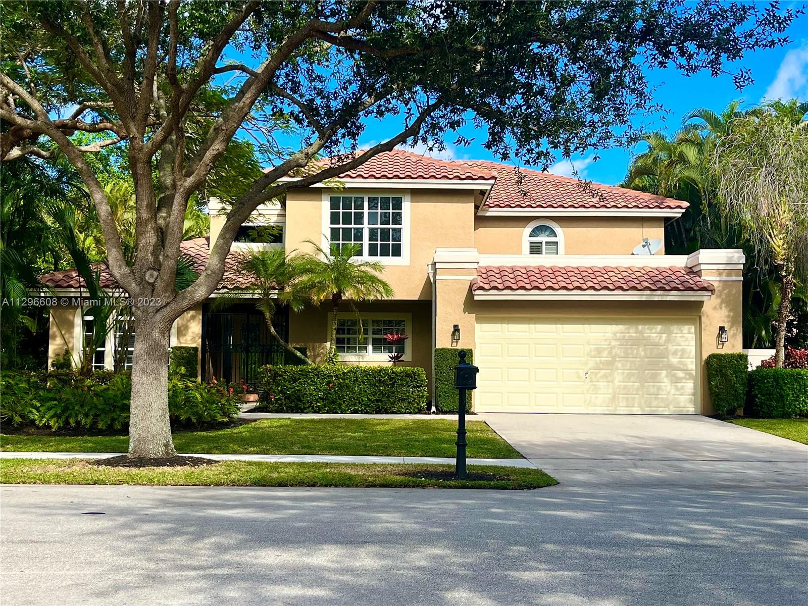 2875 Northwest 28th Street Boca Raton, FL 33434 - Photo 2 of 32 a front view of a house with a yard