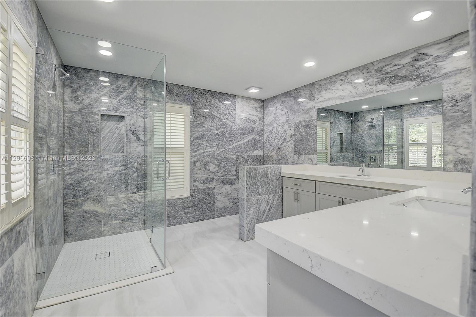 2875 Northwest 28th Street Boca Raton, FL 33434 - Photo 25 of 32 a bathroom with a sink mirror and shower