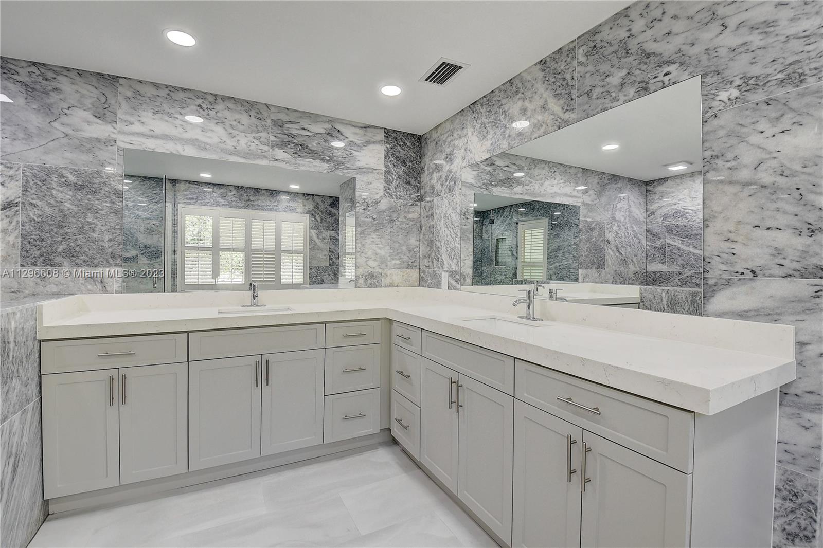 2875 Northwest 28th Street Boca Raton, FL 33434 - Photo 26 of 32 a bathroom with double sink and a mirror