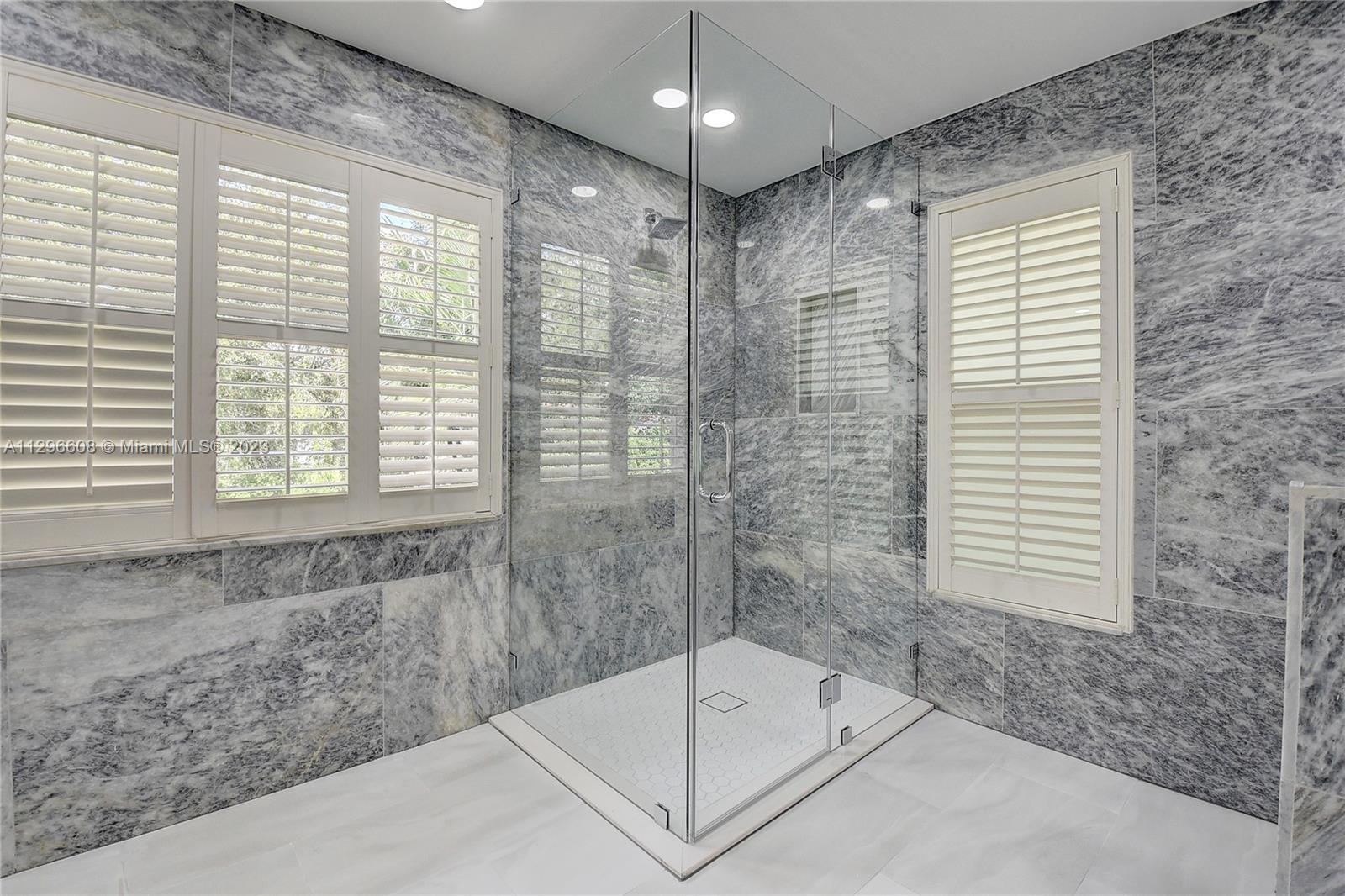2875 Northwest 28th Street Boca Raton, FL 33434 - Photo 27 of 32 a bathroom with a bathtub and a shower