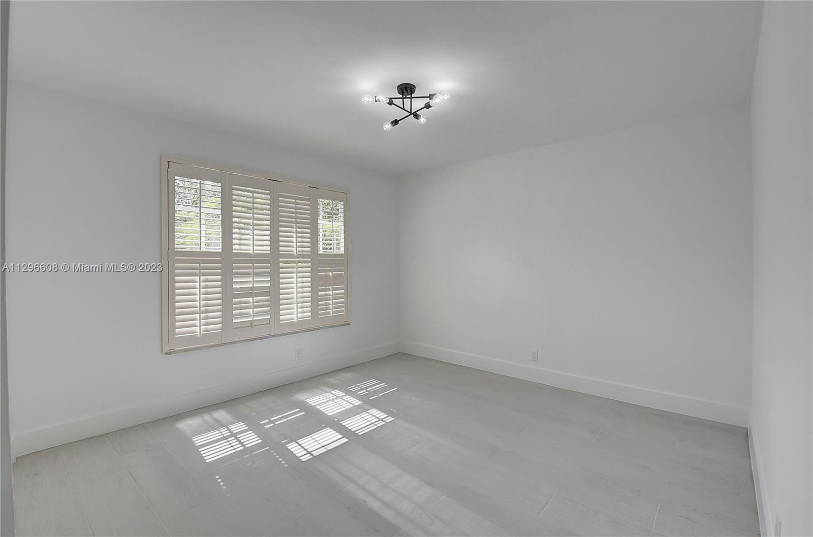 2875 Northwest 28th Street Boca Raton, FL 33434 - Photo 29 of 32 a view of an empty room with a window