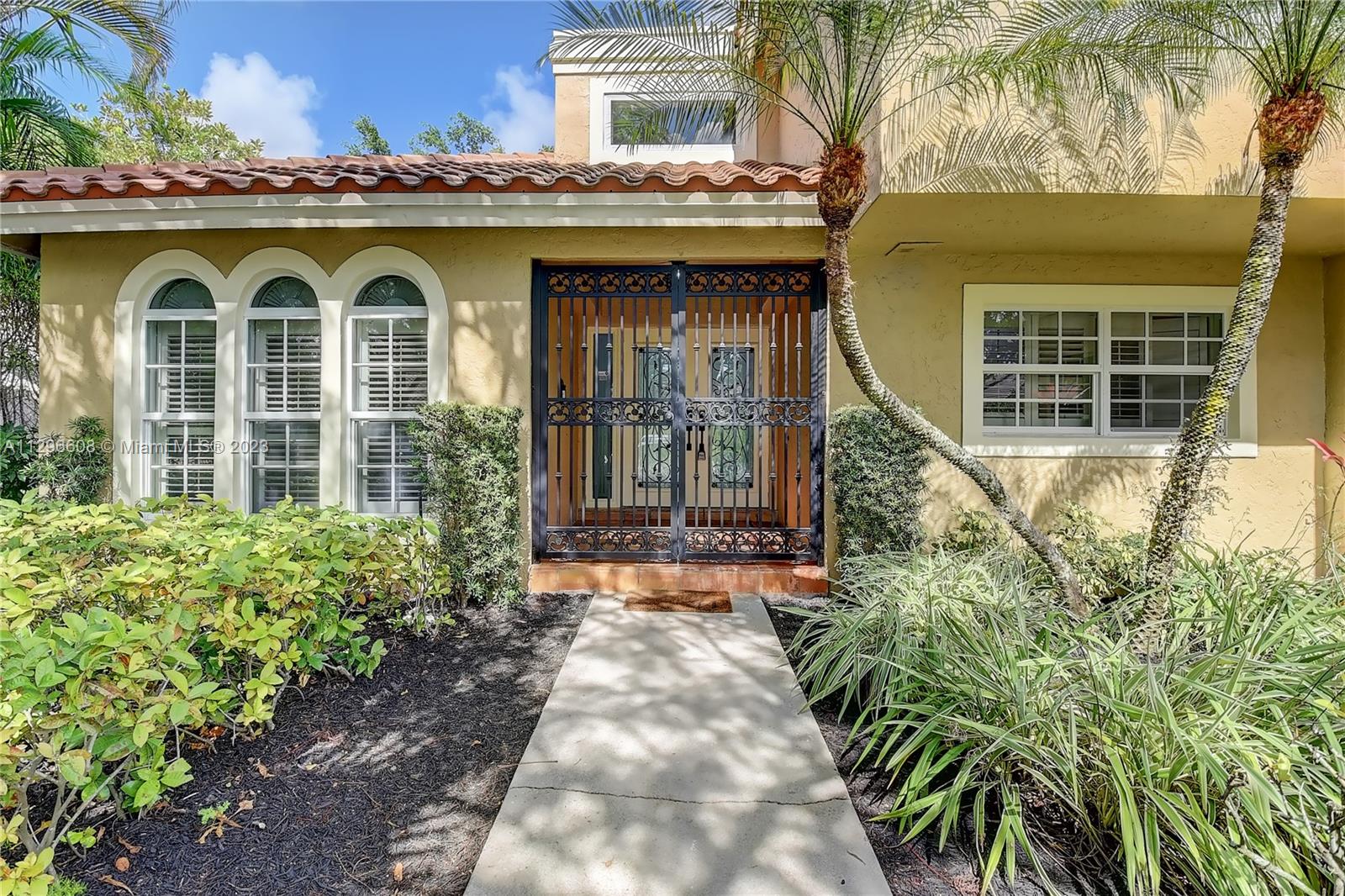 2875 Northwest 28th Street Boca Raton, FL 33434 - Photo 3 of 32 a front view of a house with garden