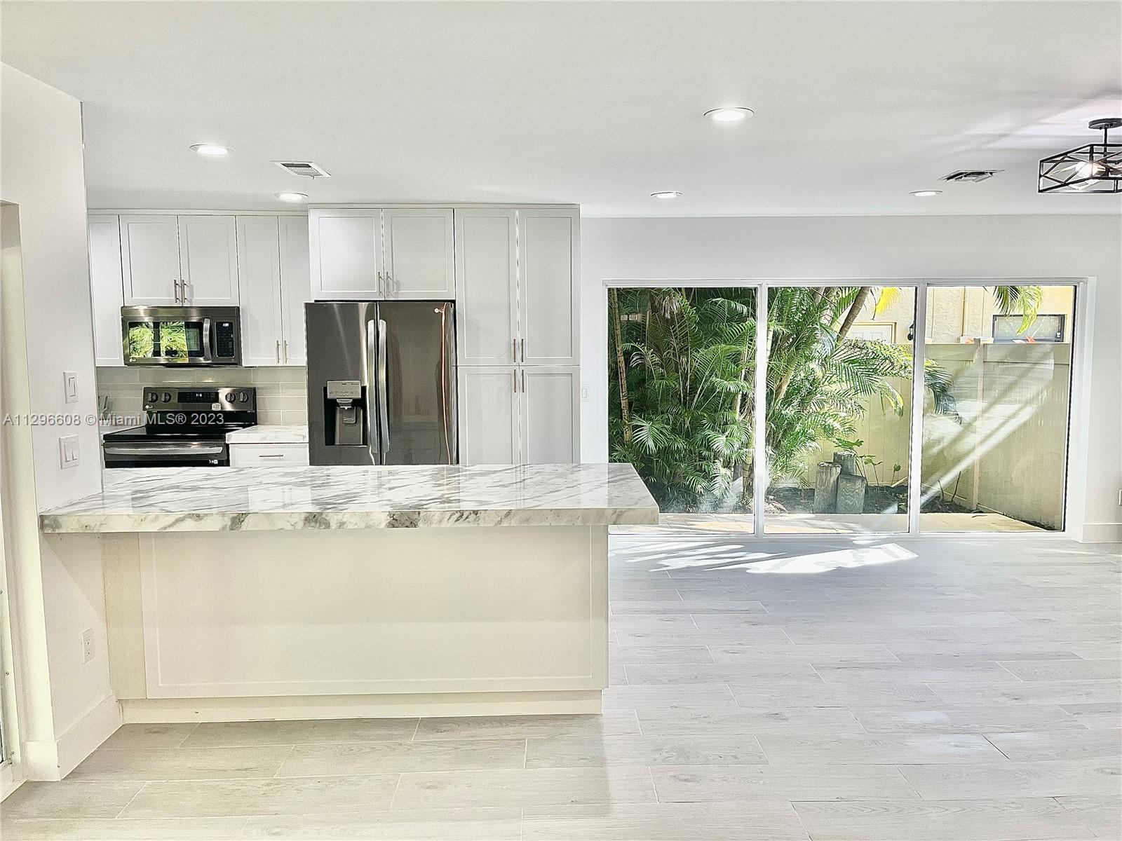 2875 Northwest 28th Street Boca Raton, FL 33434 - Photo 5 of 32 a view of kitchen with stainless steel appliances granite countertop cabinets and a counter top space