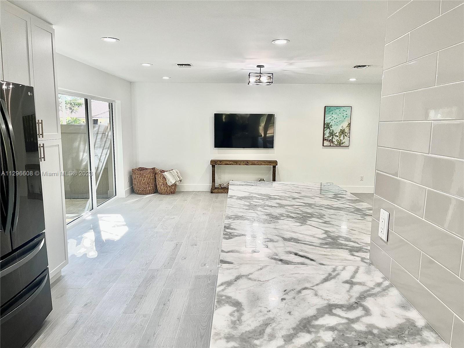 2875 Northwest 28th Street Boca Raton, FL 33434 - Photo 8 of 32 a view of a livingroom with a flat screen tv