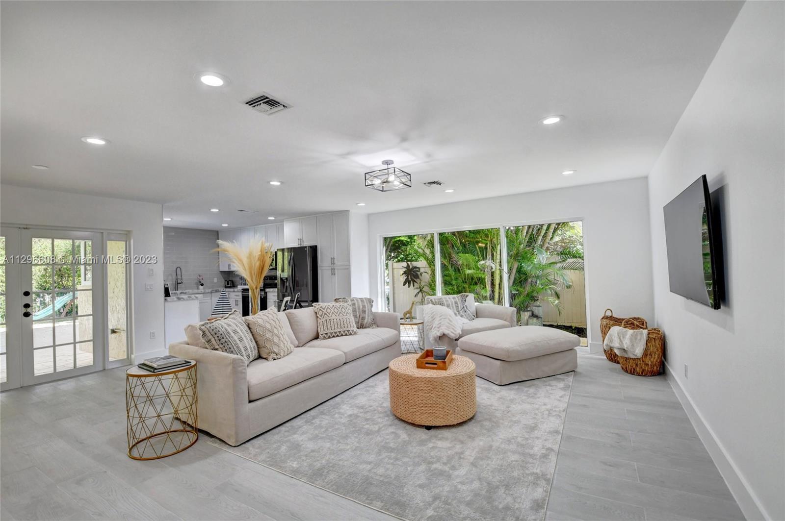 2875 Northwest 28th Street Boca Raton, FL 33434 - Photo 9 of 32 a living room with furniture and a flat screen tv