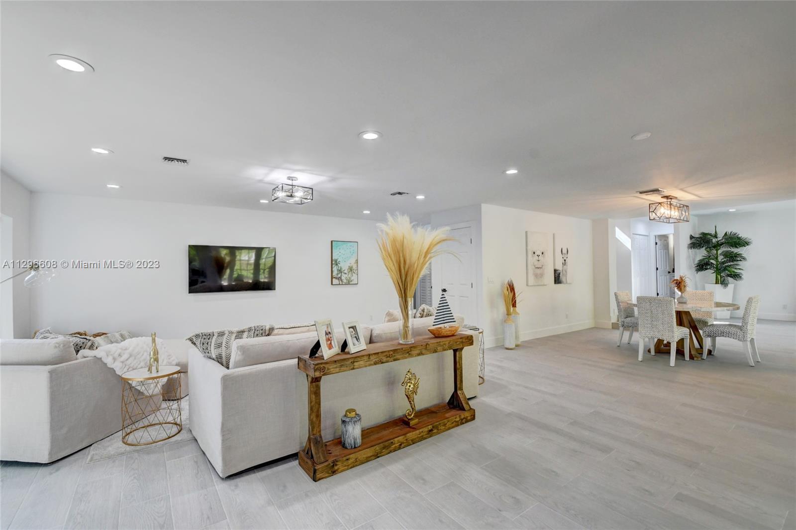 2875 Northwest 28th Street Boca Raton, FL 33434 - Photo 10 of 32 a living room with furniture kitchen view and a wooden floor