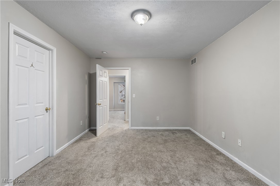 1333 Derbydale Road Akron, OH 44306 - Photo 15 of 29 Primary bedroom featuring an ensuite bath and walk-in closet, light carpet and paint.