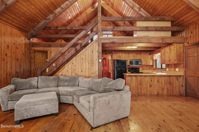 a living room with furniture and kitchen view