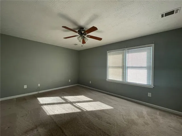 a view of a big room with carpet