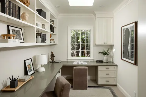 a kitchen with cabinets and window