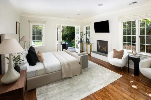 a bedroom with a large bed and a flat screen tv
