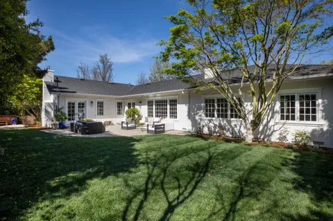 a front view of a house with a garden