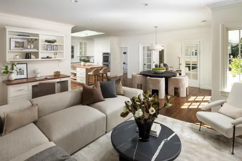 a living room with furniture or kitchen and a chandelier