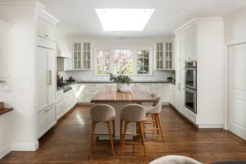 a dining room with furniture and wooden floor
