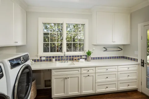 a kitchen with sink cabinets and washer