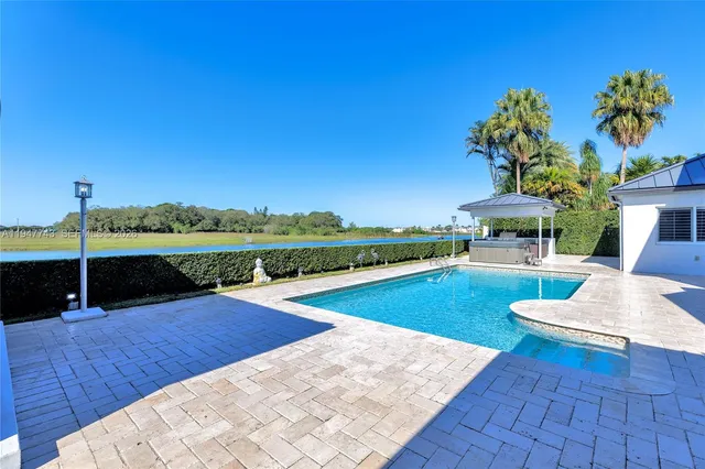 a spacious bathroom with double vanity a mirror a bathtub and shower
