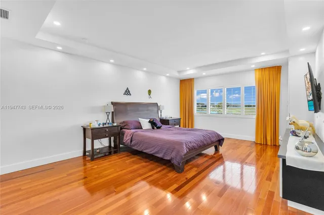 a bathroom with a granite countertop sink a toilet a mirror and shower