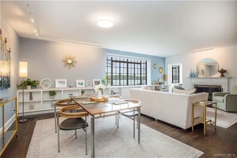 a living room with furniture a window and a table