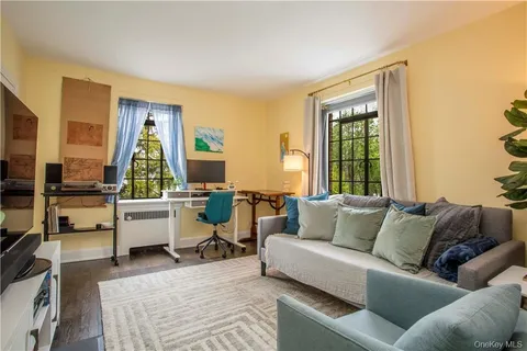 a living room with furniture and large window