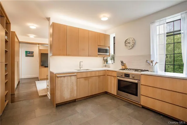 a kitchen with stainless steel appliances granite countertop a stove and a sink