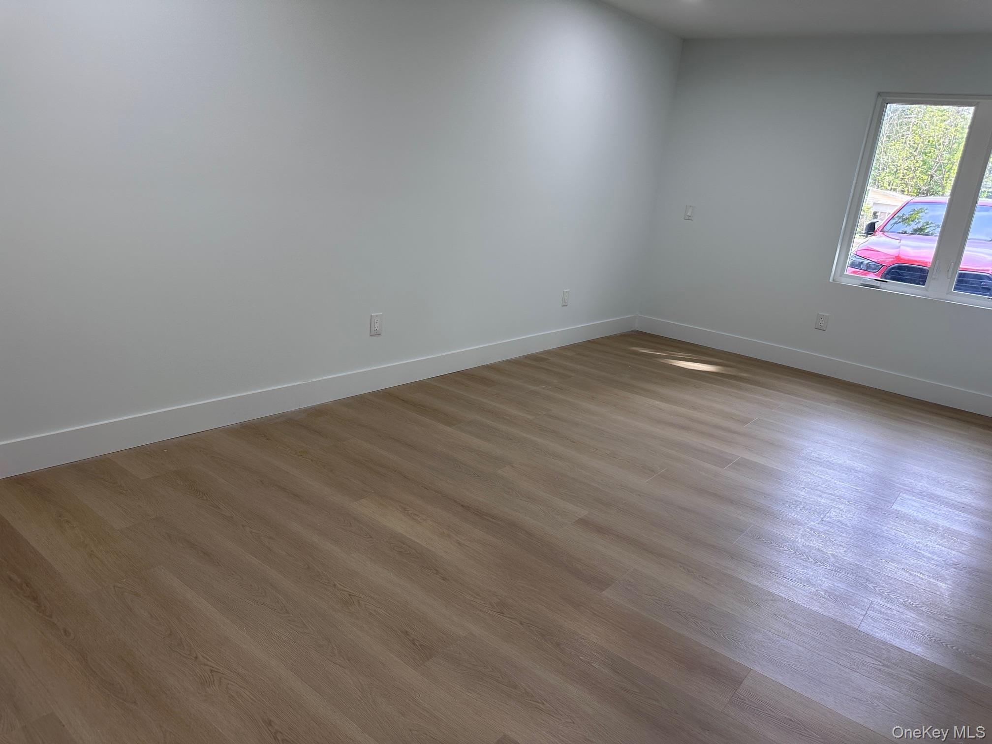 525 Mill Brook Drive Esopus, NY 12466 - Photo 16 of 17 a view of empty room with wooden floor and fan