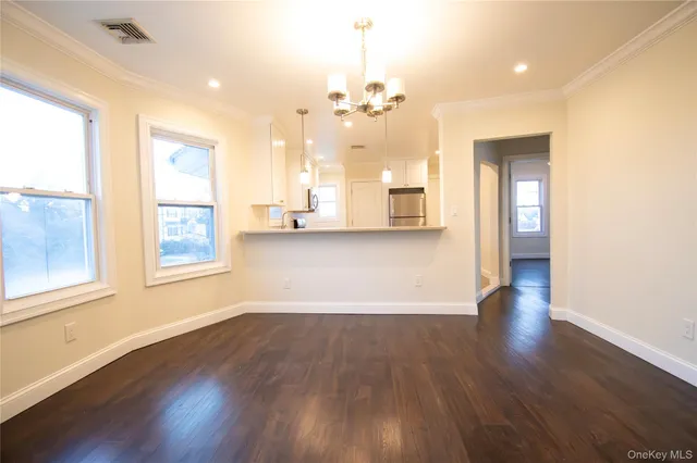 a view of a room with wooden floor and large windows