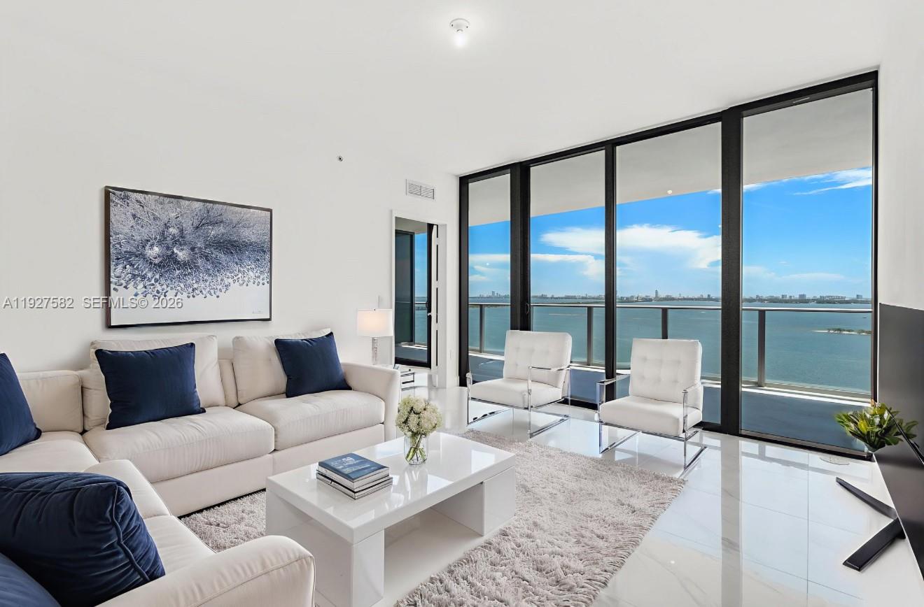 700 Northeast 24th Street, Unit 3803 Miami, FL 33137 - Photo 12 of 22 a living room with furniture and a large window