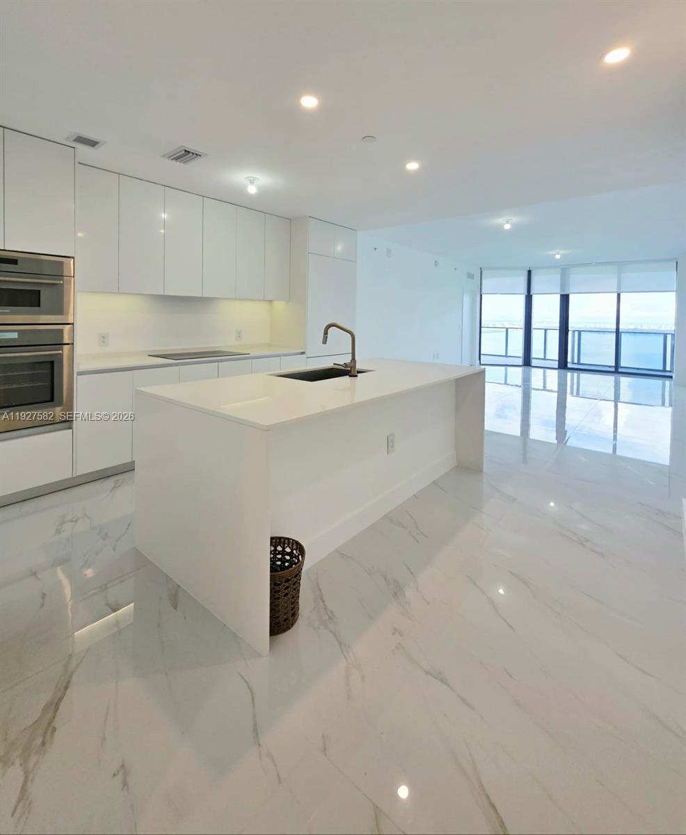 700 Northeast 24th Street, Unit 3803 Miami, FL 33137 - Photo 13 of 22 a view of kitchen with center island and windows