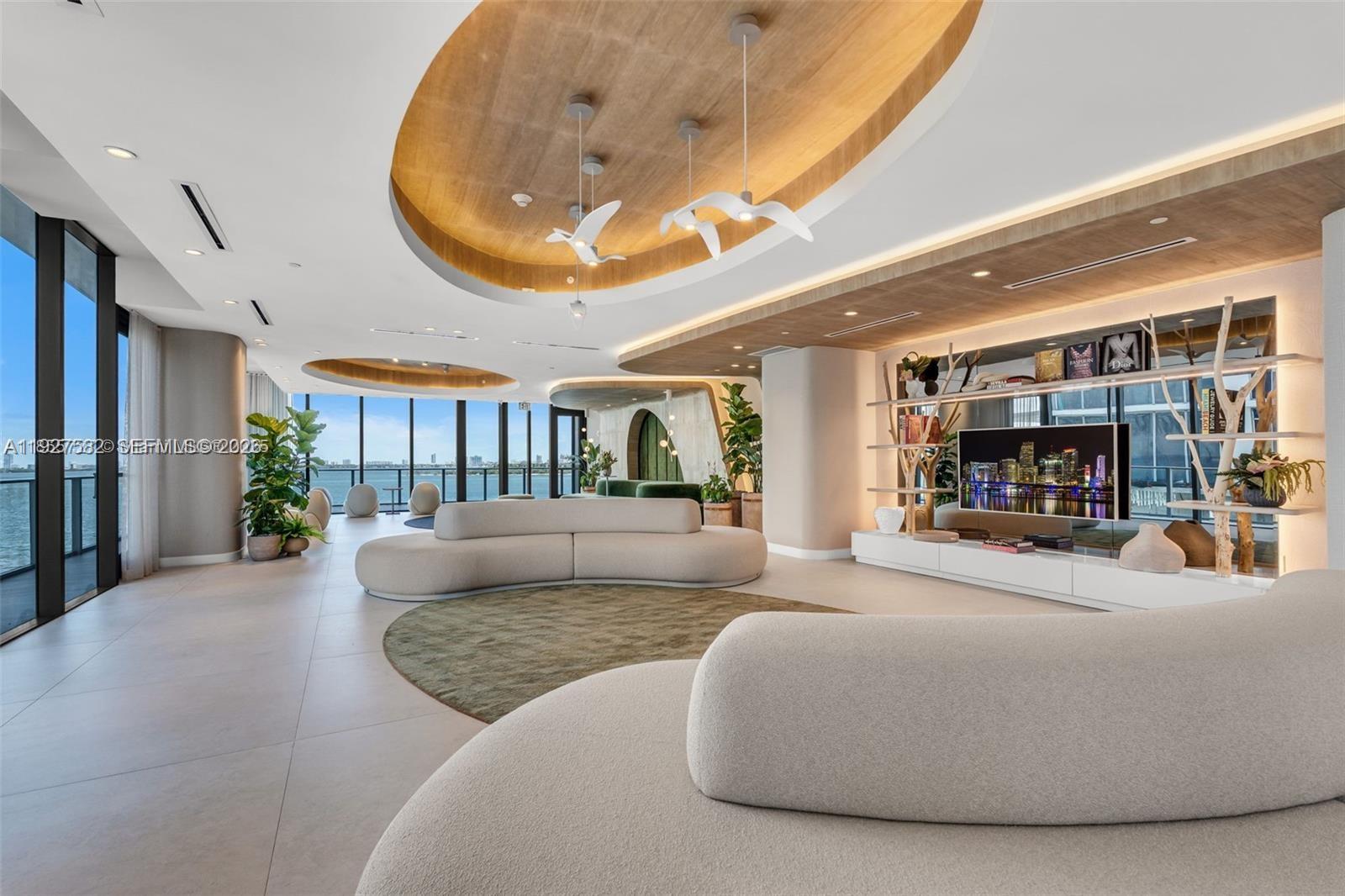 700 Northeast 24th Street, Unit 3803 Miami, FL 33137 - Photo 17 of 22 a living room with furniture and a fireplace