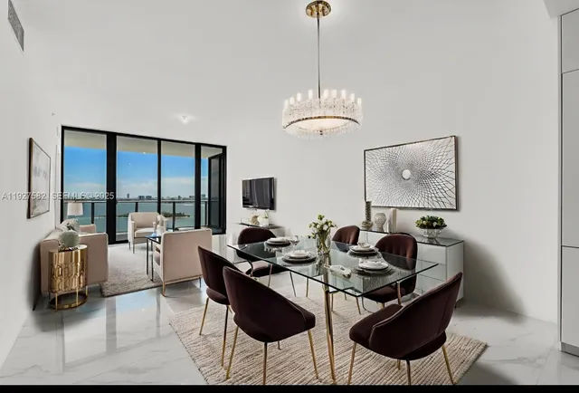 a dining room with furniture a chandelier and window