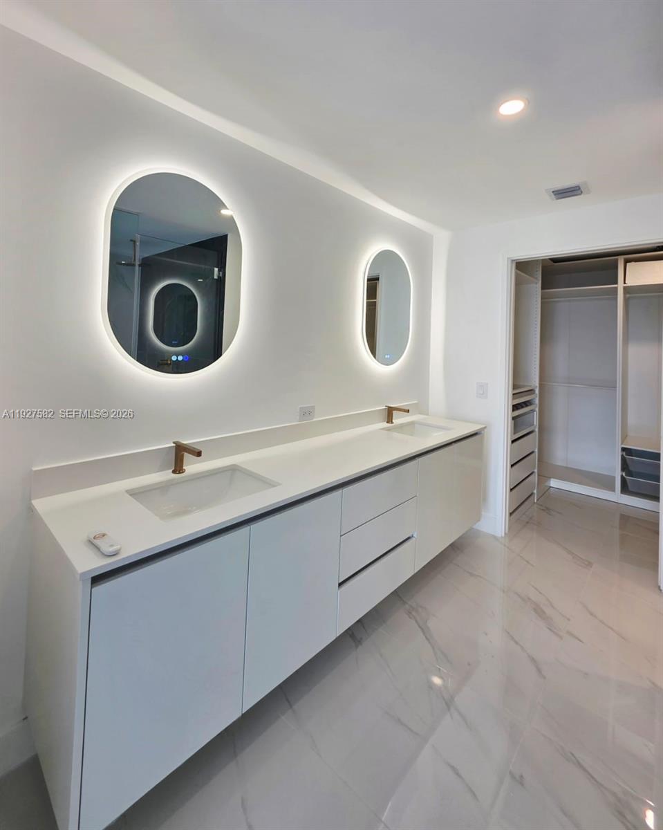 700 Northeast 24th Street, Unit 3803 Miami, FL 33137 - Photo 10 of 22 a bathroom with a double vanity sink and a mirror