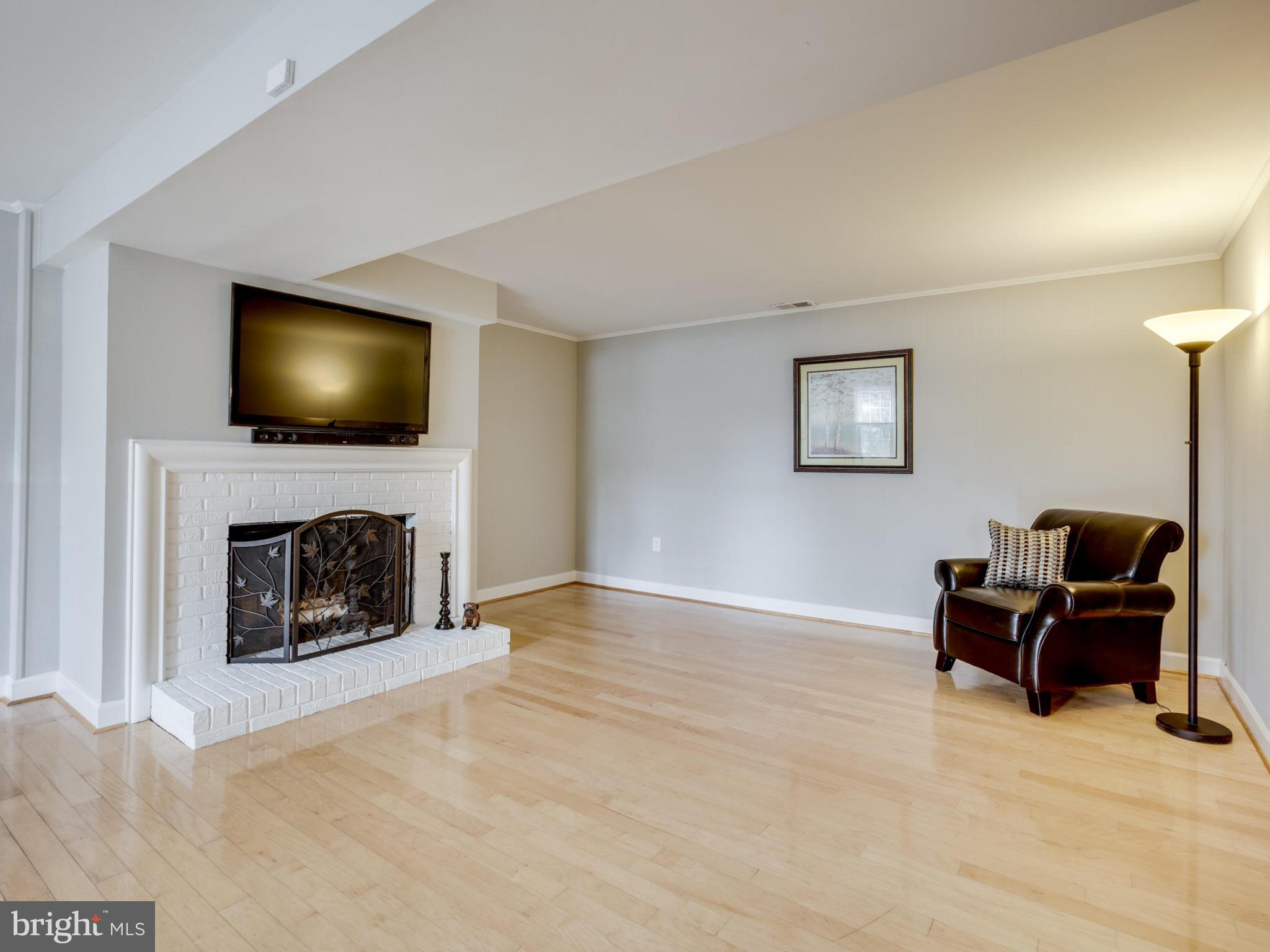 6502 Shipyard Place Falls Church, VA 22043 - Photo 23 of 30 a living room with furniture and a fireplace