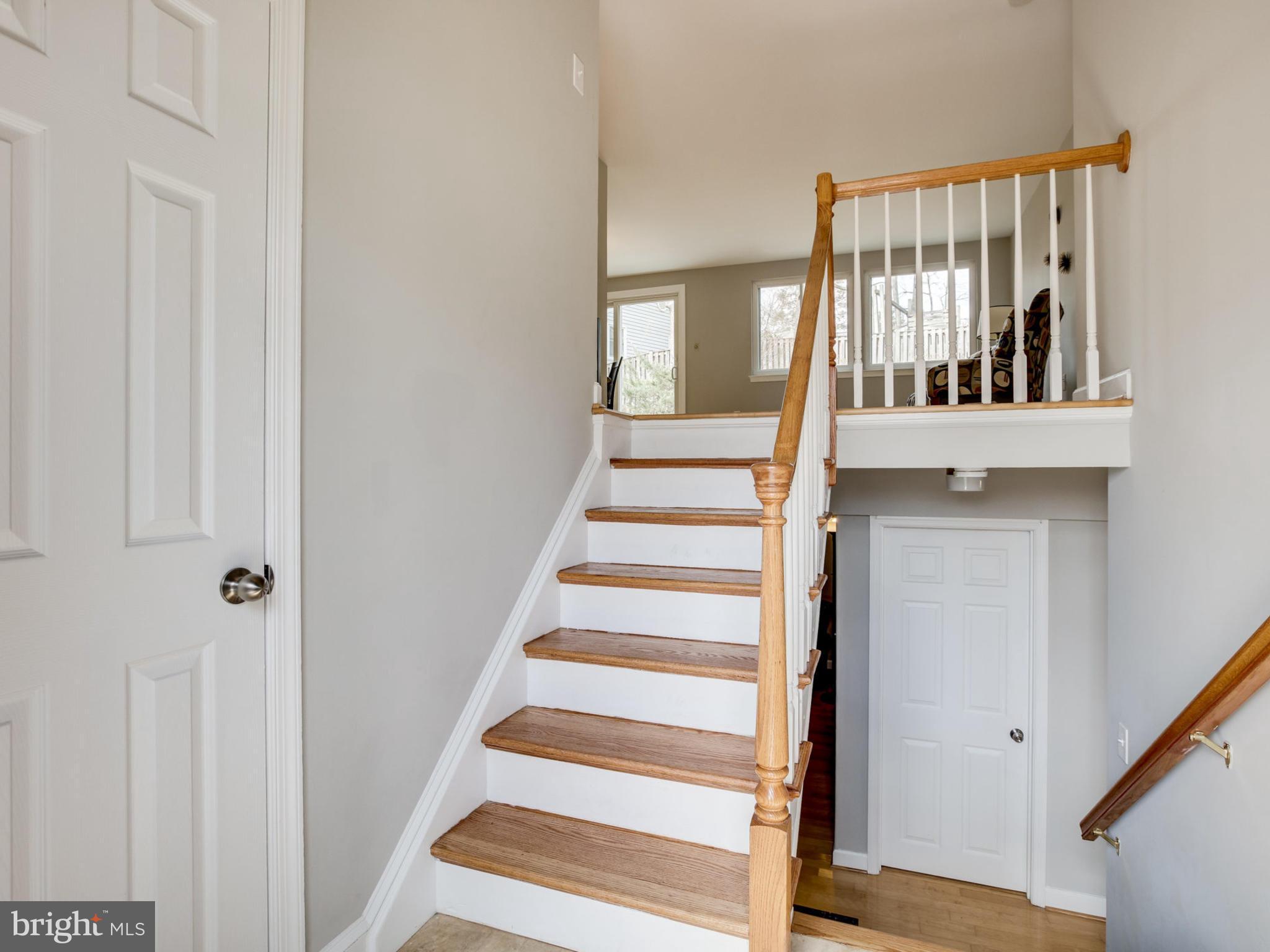 6502 Shipyard Place Falls Church, VA 22043 - Photo 9 of 30 a view of staircase with wooden floor and windows