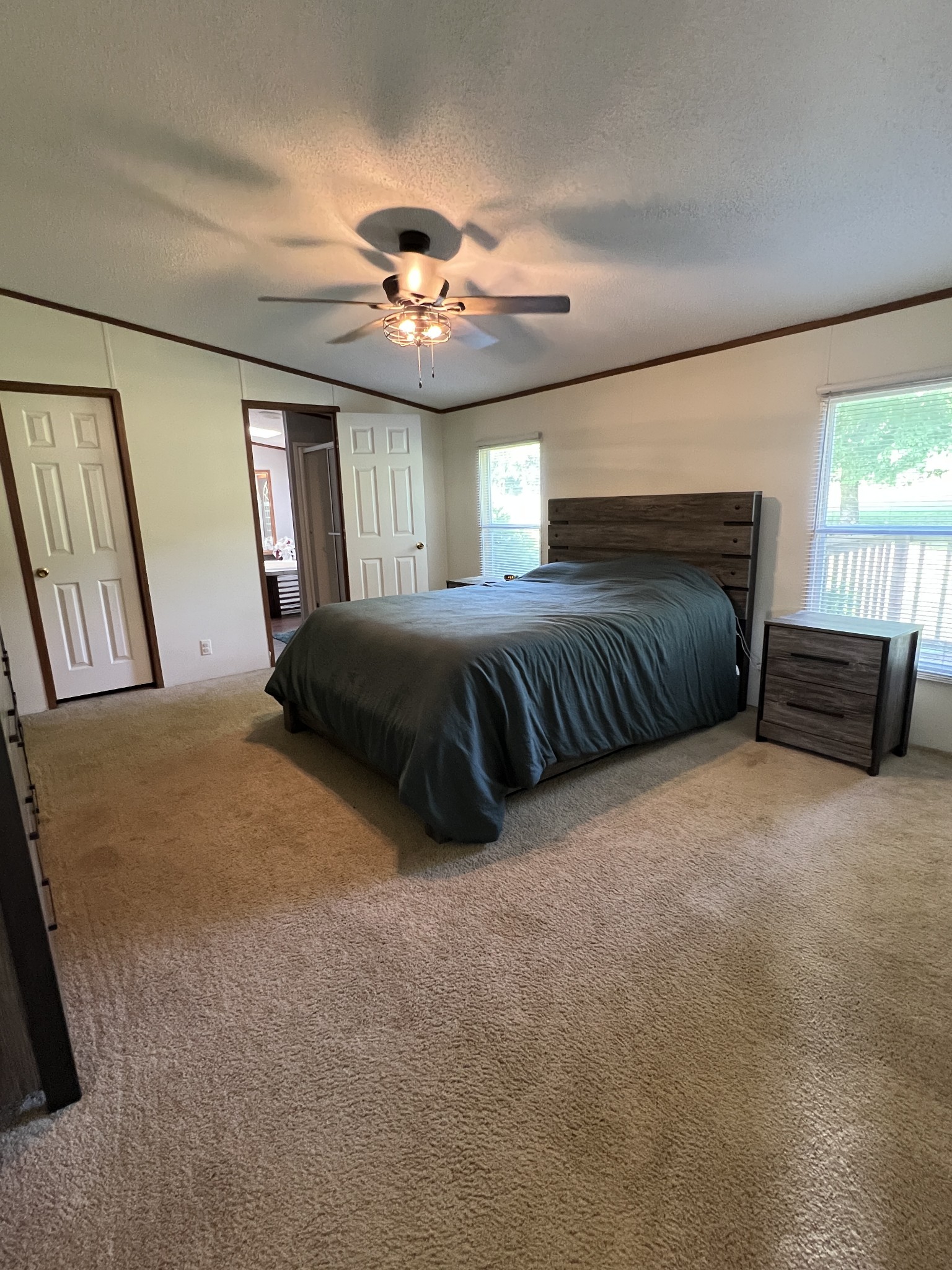 3538 Beasleys Bend Road Lebanon, TN 37087 - Photo 38 of 49 a spacious bedroom with a bed and a chandelier