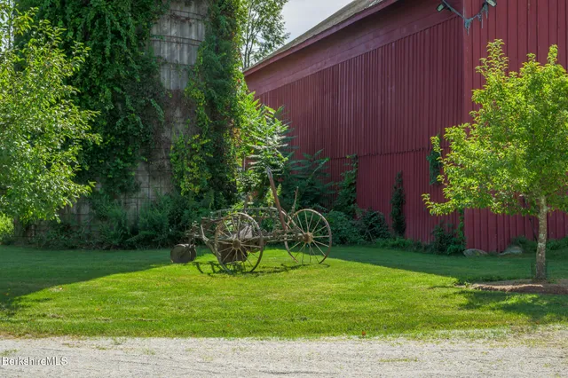 a view of an empty room with wooden floor and a windows