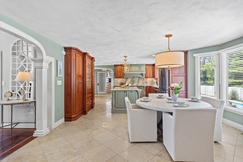 6 David Drive Andover, MA 01810 - Photo 9 of 41 a room with stainless steel appliances kitchen island granite countertop a refrigerator a sink a stove and white cabinets with wooden floor