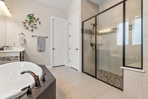 a bathroom with a bathtub and shower