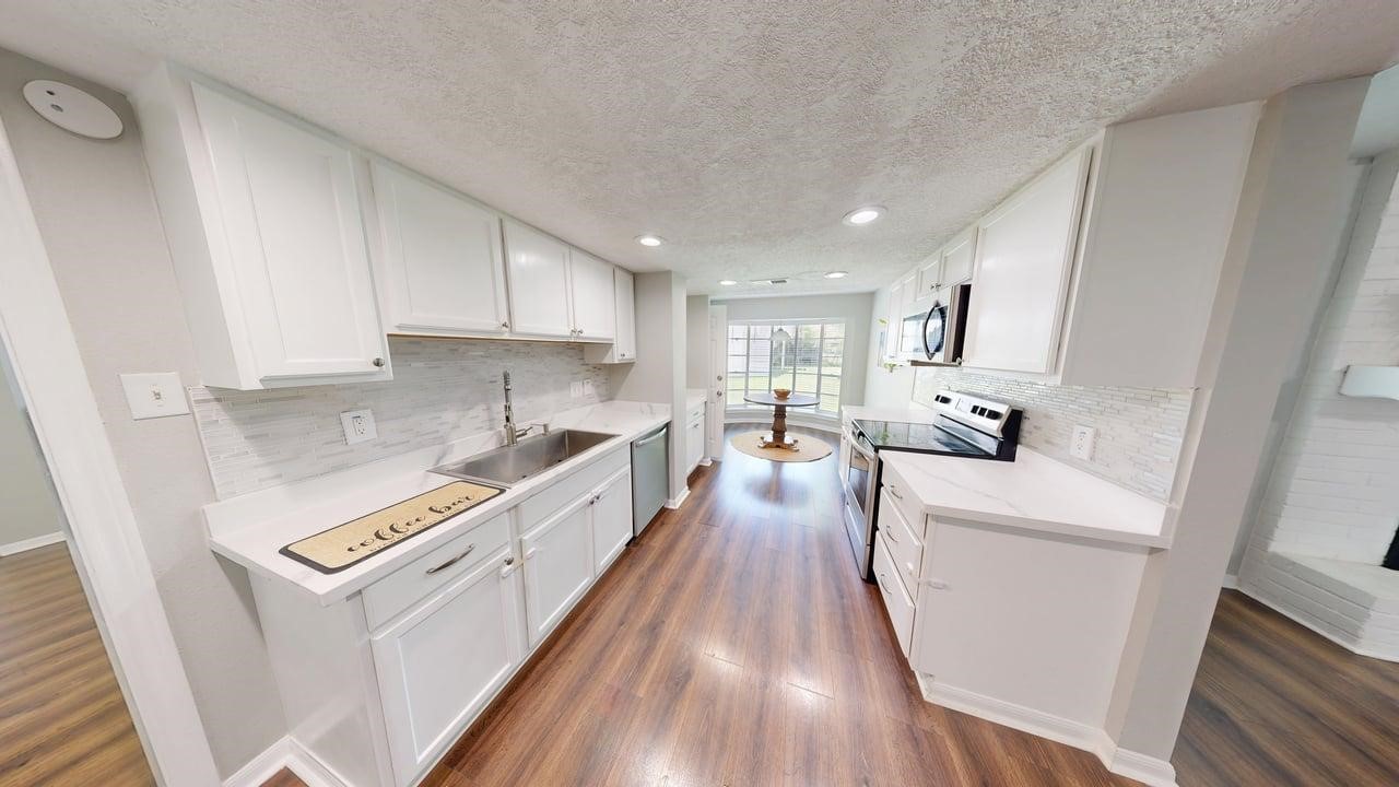 619 Cotter Drive Spring, TX 77373 - Photo 18 of 50 a kitchen with sink a refrigerator and a stove top oven